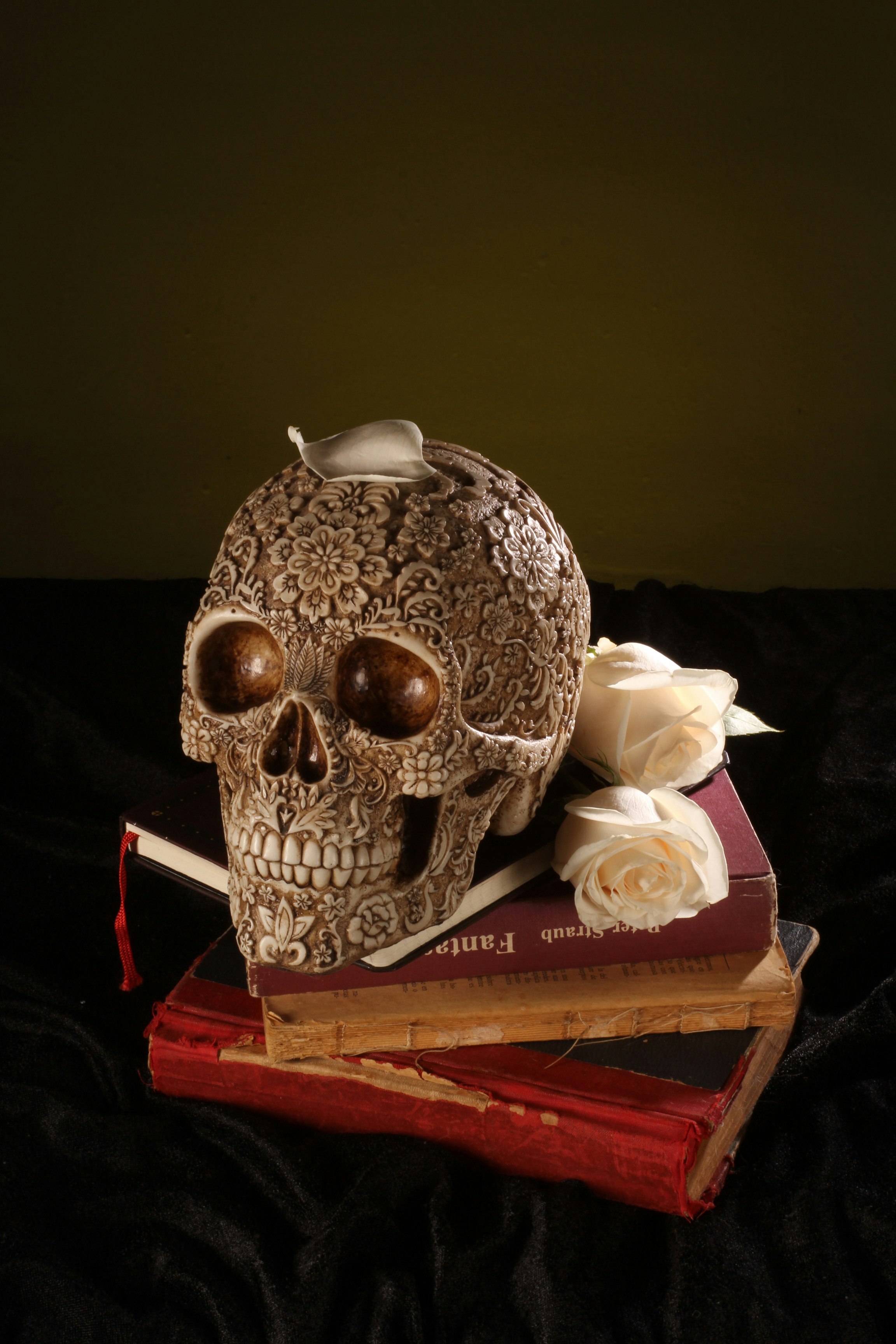 white and brown skull ceramic figurine